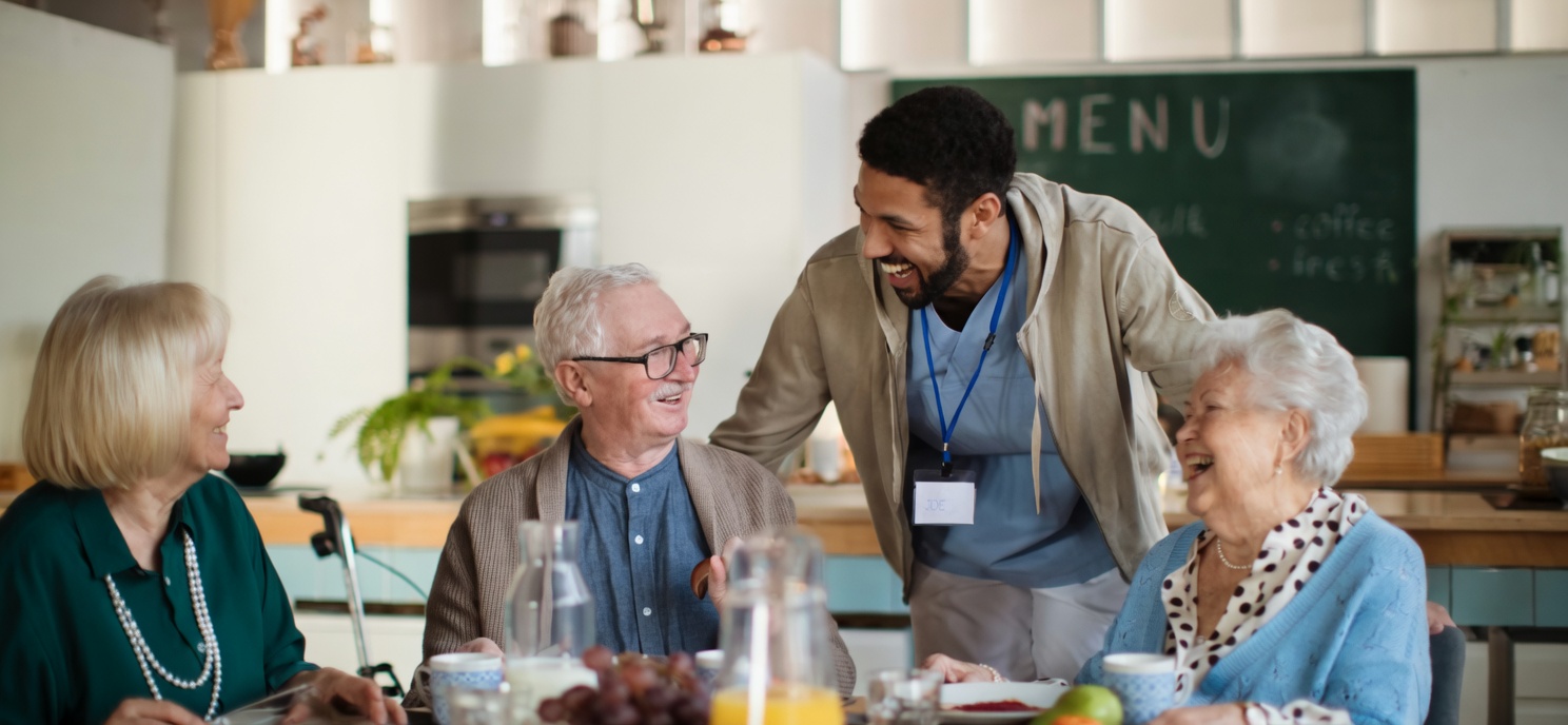 Senior woman smiling while holding hands with caregiver